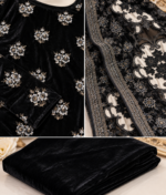 Closeup details of black velvet embroidered shirt, embroidered shawl with net patches and matching trousers