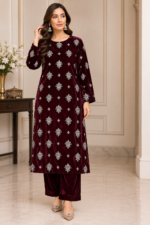 Woman wearing a burgundy velvet embroidered shirt and matching trousers in a front pose without shawl