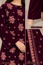 Closeup of deep maroon velvet shirt with intricate floral embroidery and small motifs