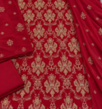 Closeup of deep red chiffon fabric with intricate gold handwork embroidery