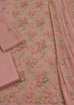 Closeup of dusty rose chiffon fabric with multicolor handmade floral embroidery