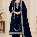 Navy blue velvet unstitched 3-piece suit with intricate silver embroidery, embroidered kameez, matching sleeves, and bordered velvet dupatta.
