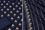 Closeup of navy blue chiffon suit fabric with floral embroidery and embroidered dupatta