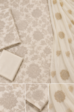 Closeup of ivory beige silk unstitched fabric with floral embroidery