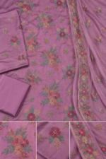 Closeup of mauve silk unstitched fabric with floral embroidery